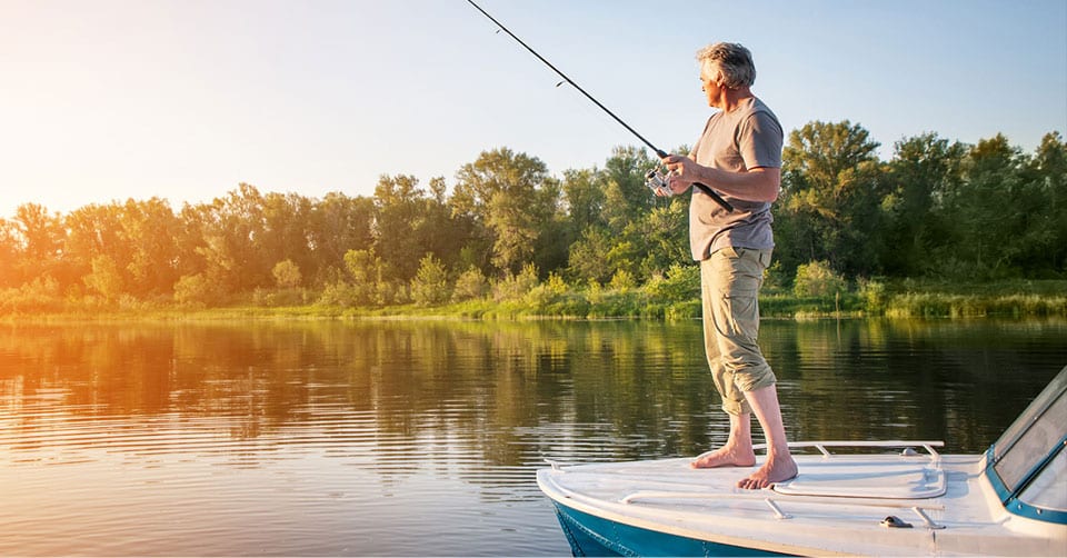 Man fishing off of front of boat