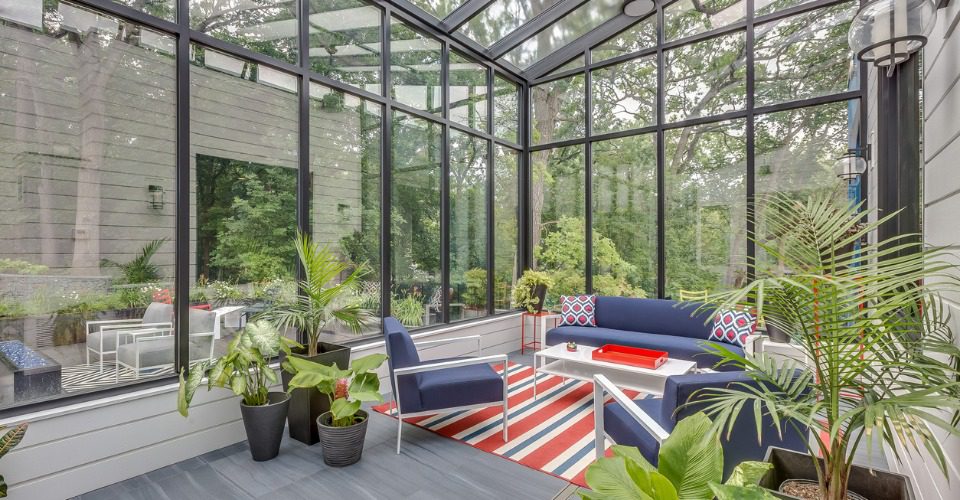 sunroom with blue furniture and red, white, and blue carpet