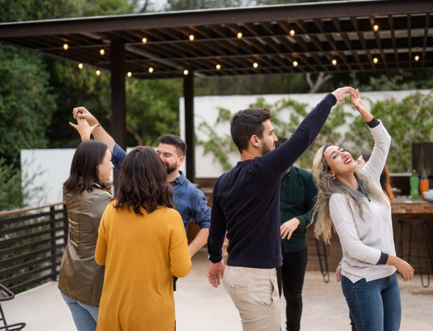 People gathered around outdoor kitchen